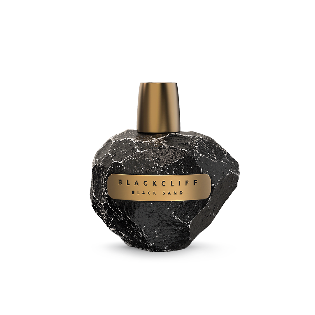 Black Sand perfume bottle: black stone-textured heart shape with gold cap and label.