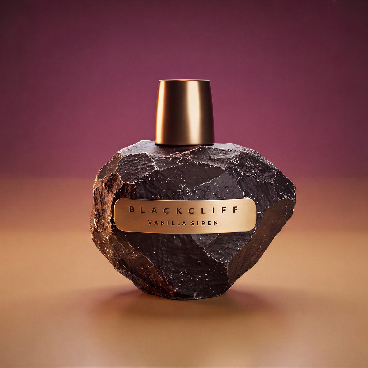 Vanilla Siren perfume bottle, dark faceted stone body with gold cap and label