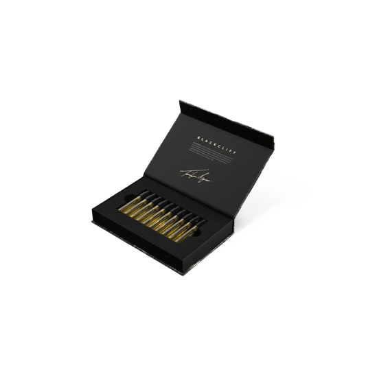 Open 10-pack discovery set box with inner black tray and row of small bottles