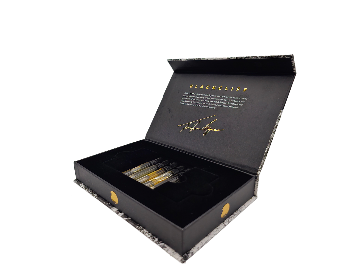 Five mini fragrance bottles in open black gift box, angled view