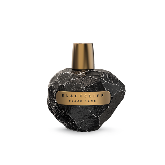 Black Sand perfume bottle: black stone-textured heart shape with gold cap and label.