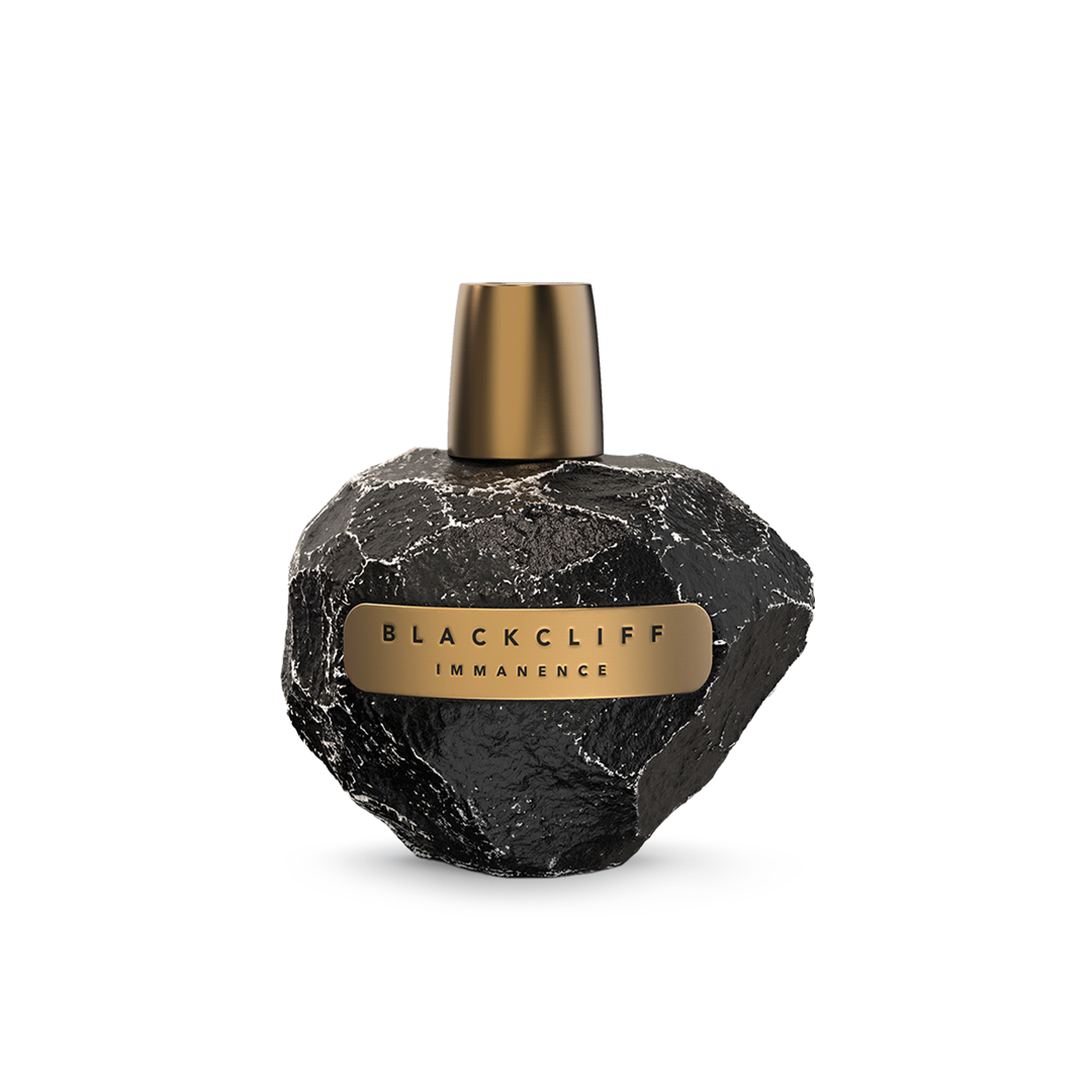 Perfume bottle with textured black glass and gold cap, featuring an Immanence label