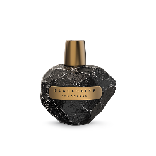 Perfume bottle with textured black glass and gold cap, featuring an Immanence label
