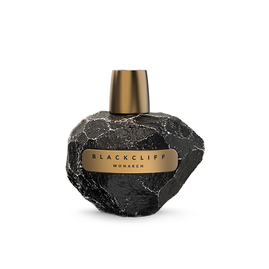 Spherical black perfume bottle with gold cap and gold label reading Blackcliff Monarch